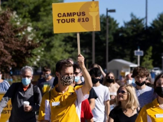 An Admissions Ambassador gives an outdoor tour of Rowan Campus to prospective students and their families.