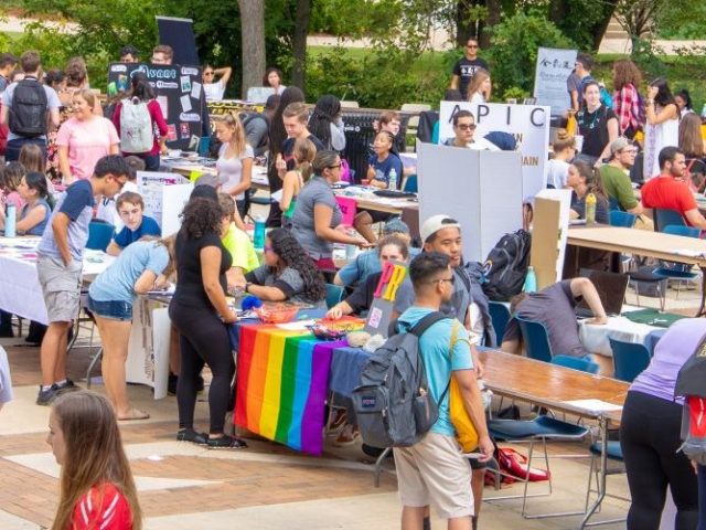 Students walking around the Rowan clubs fair event featuring different clubs and organizations on campus.