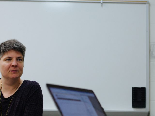 Professor Zundl listening to a student.