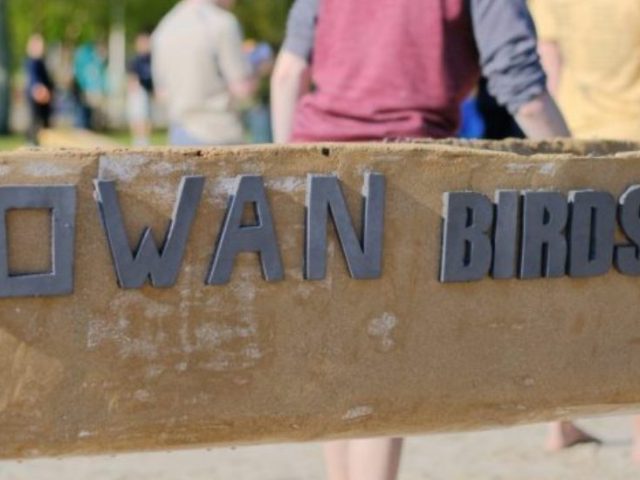 A close up of the side of the Rowan concrete canoe.