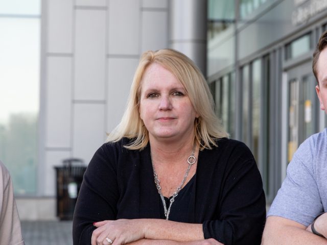 Kellie Stout sits with her two sons behind Business Hall at Rowan University.