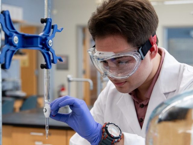 Nathaneal studies his experiment with a serious face.