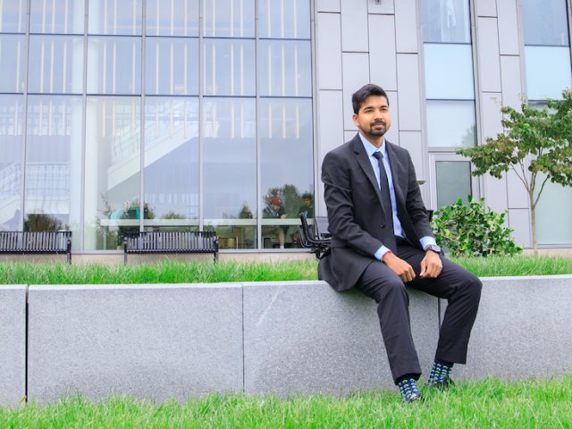 Somyaranjan Rout sits behind business hall.