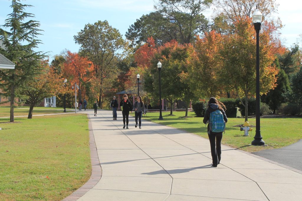 Students walking through campus on a fall day.