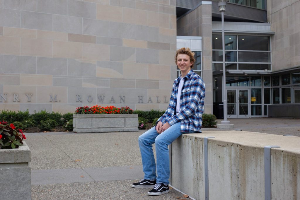 John Schiede sitting outside of the Henry M Rowan College of Engineering