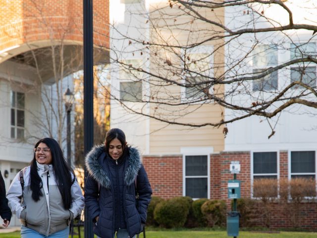 Rosa walks with two friends through campus.