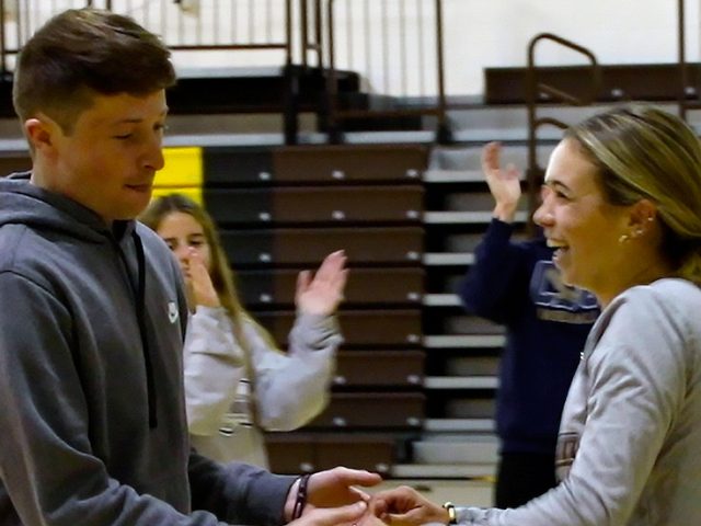 Mackenzie Saber dancing with a partner inside of Esby Gym