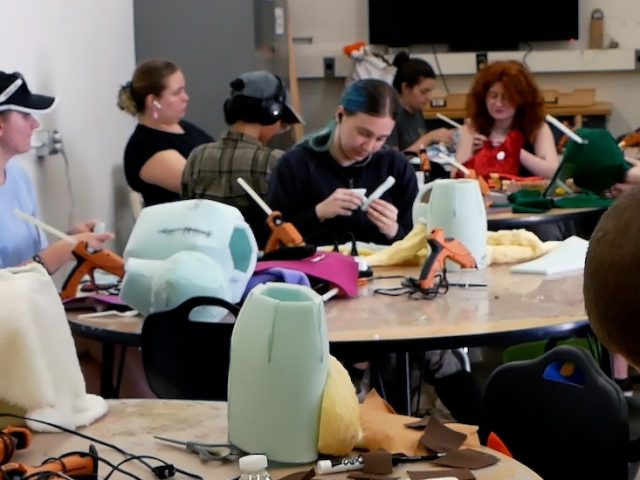 Students in Puppetry class work alongside each other in class.