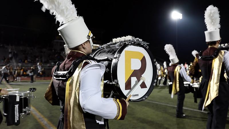 An on field close up of a drum major performing with Rowan's marching band. 