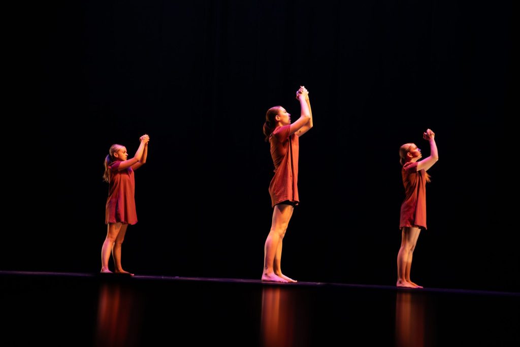 Three company members performing in Fundraising Chair Emma Margolies piece titled "00000."