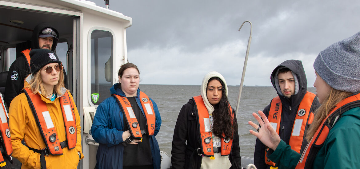 A group of Rowan environmental science students on a boat for their Oceans class.