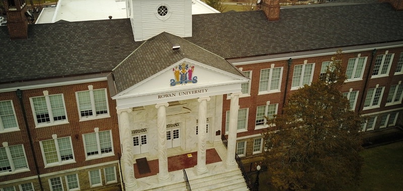 A drone photo looking down toward the face of historic Bunce Hall at Rowan University. 