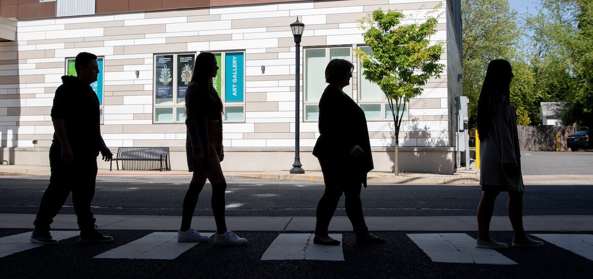 Rowan University professor and three students recreate the iconic Abbey Road cover from the Beatles, walking across the street from the advertising building.