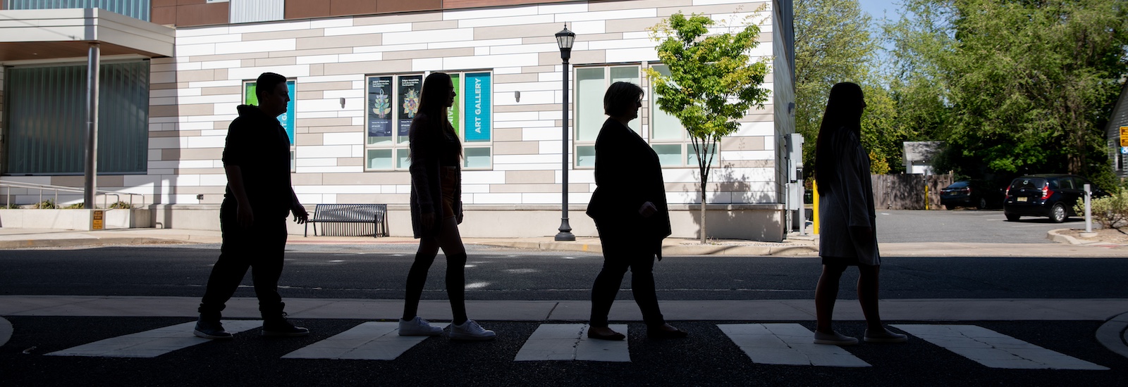 Rowan University professor and three students recreate the iconic Abbey Road cover from the Beatles, walking across the street from the advertising building.