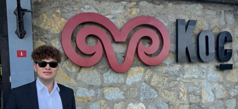 Tyler with a Koç Holding sign