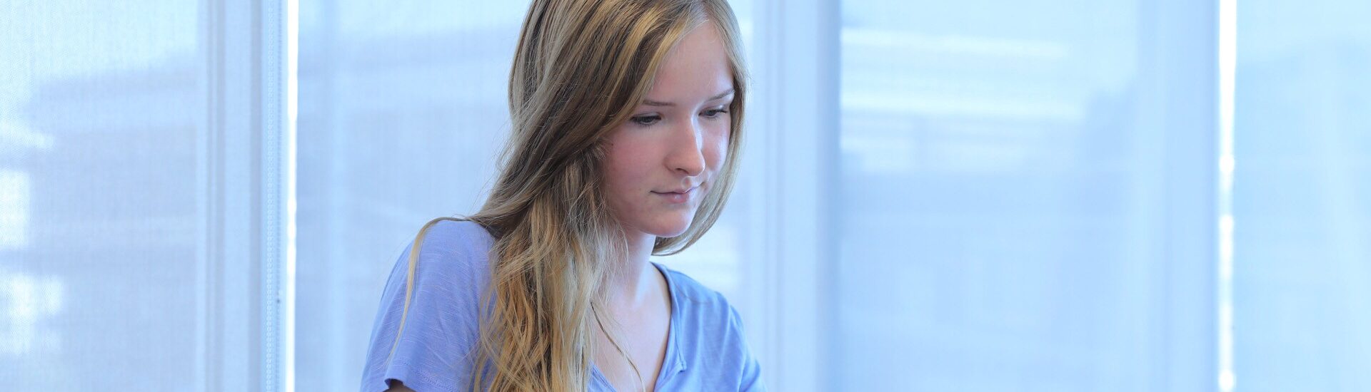 Student studying for an online healthcare administration degree on a laptop.