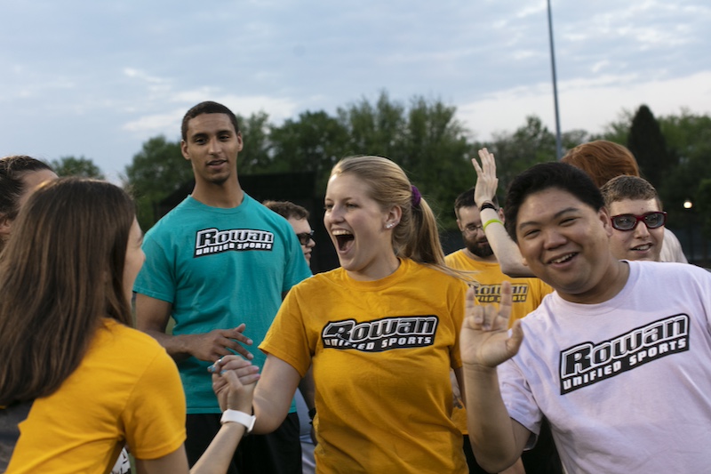 A huddle of Rowan Unified Sports relax and celebrate in a group.
