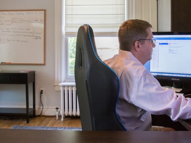 A Rowan University graduate who works in Information Technology works in his spacious home office.