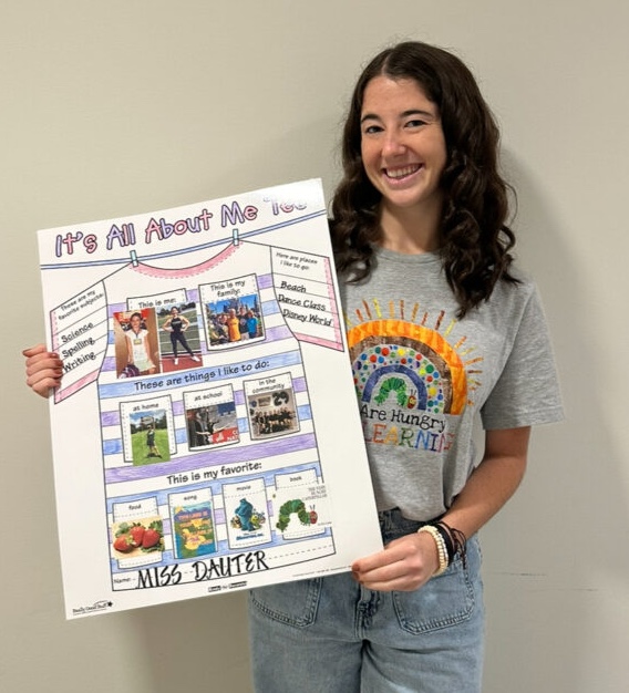 Jordyn Dauter standing with her "All About Me Tee" poster.