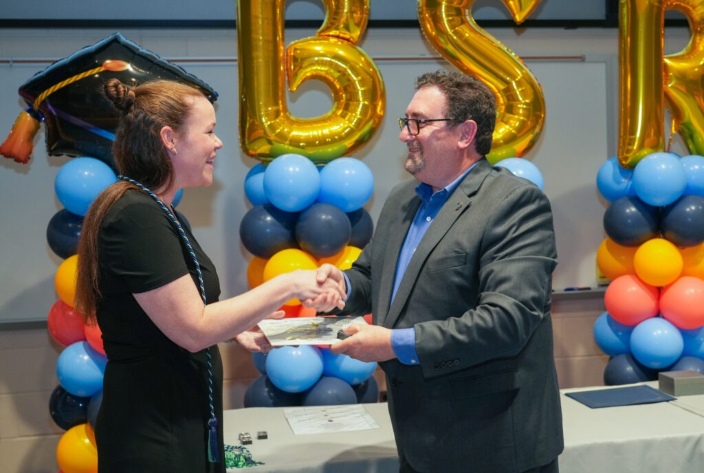 Natalie H., a student in Rowan’s bachelor's in respiratory therapy program, is recognized by faculty during an Honor Society Induction ceremony.