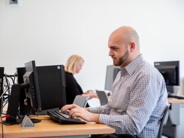 Student working on a healthcare management degree online