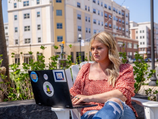 Student earning an online computer technology degree in a flexible learning space