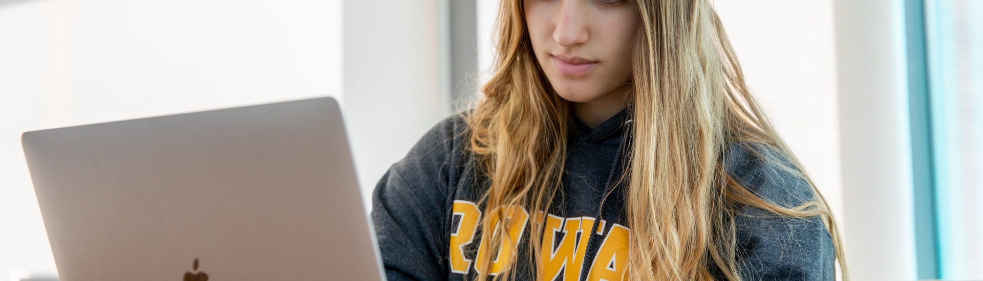 Student studying online for a construction management degree, highlighting flexible learning.