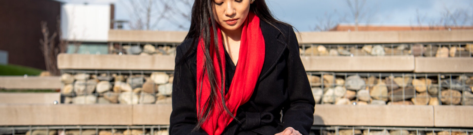 Student working independently outdoors, capturing the personalized, flexible experience of earning a business management certificate online.