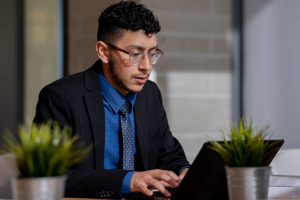 Online MBA student doing coursework on laptop