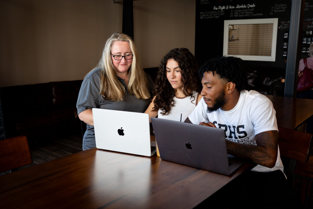 Students taking advantage of online learning support resources while working on coursework for Rowan’s respiratory therapy program in a collaborative setting