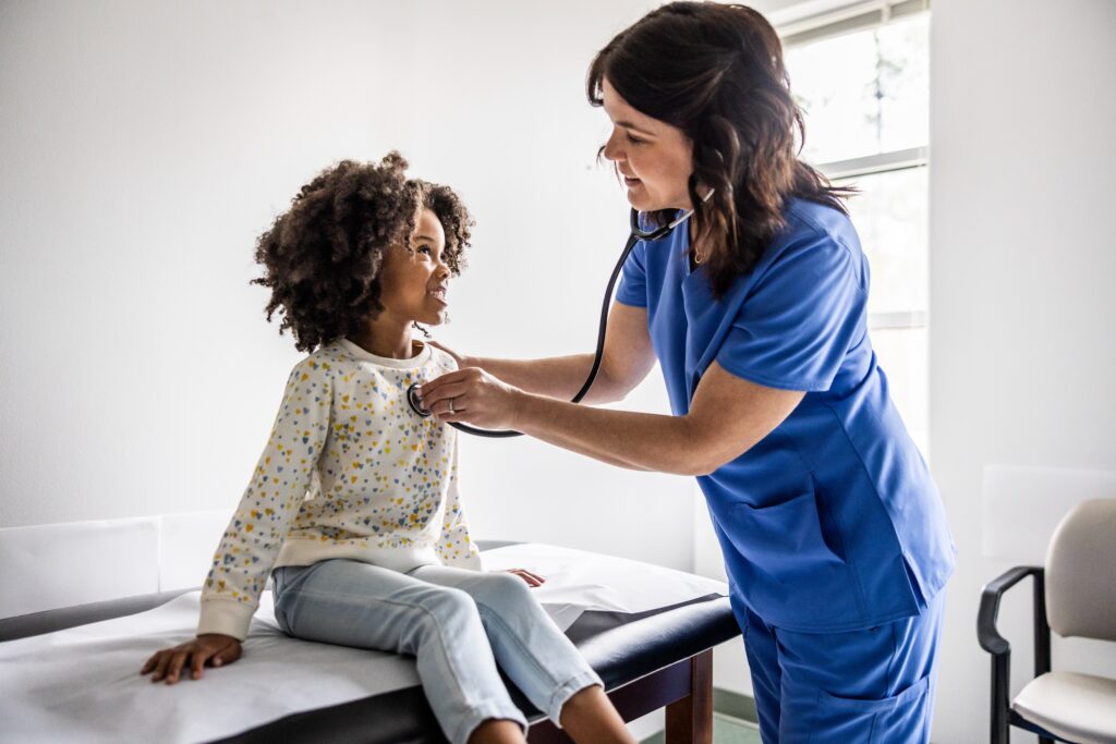 Respiratory therapist caring for a young patient while advancing their career through a bachelor’s in respiratory therapy online.