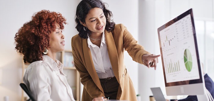 What does a data analyst do? Professionals analyzing data and discussing insights in an office setting.