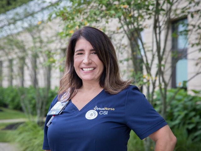 A BSN to RN nurse stands outside her healthcare setting.