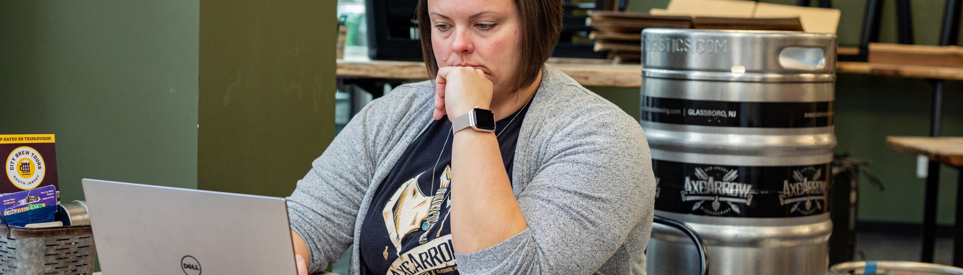 Rowan MBA student studying in a local café, showing the flexibility of fully online MBA programs.