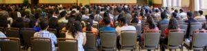 A room full of people, as seen from the back of the room, at International Students Orientation at Rowan University.