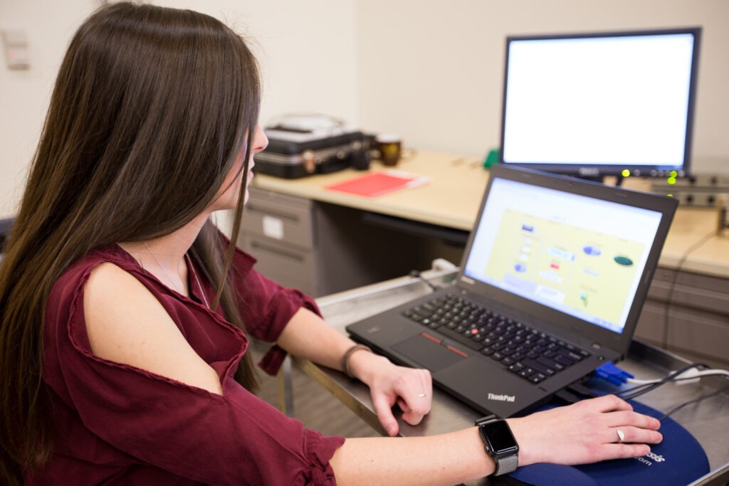 Student working on a laptop in an online course environment
