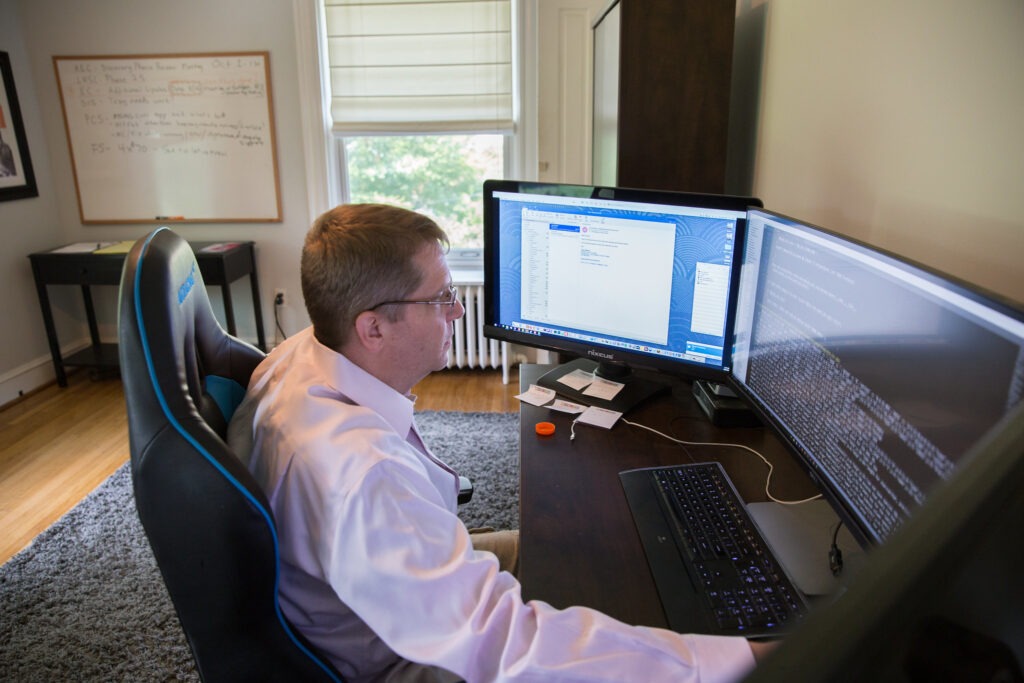 Man working from home while earning a cybersecurity masters online
