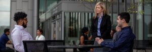 Rowan master's in cybersecurity experts sit outside an office.