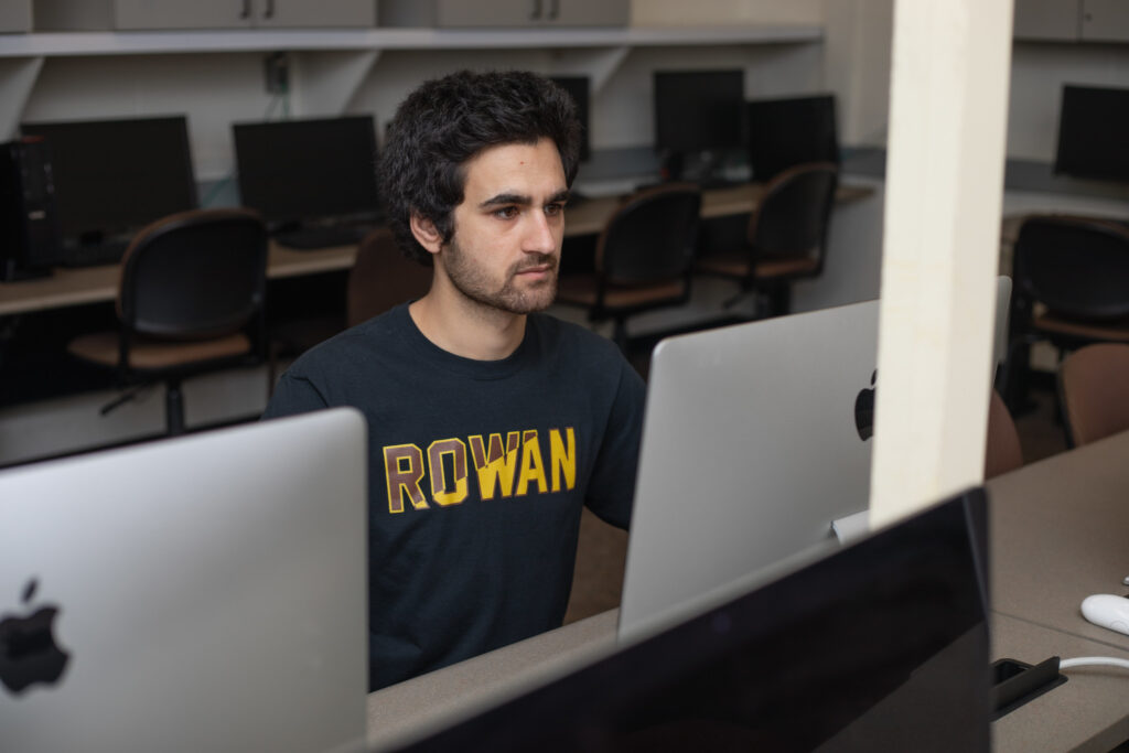 Rowan University student at computer exploring if you need a degree to be a data analyst