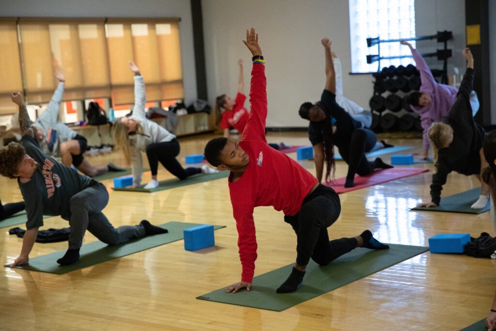A Rowan University student practices yoga in a studio.