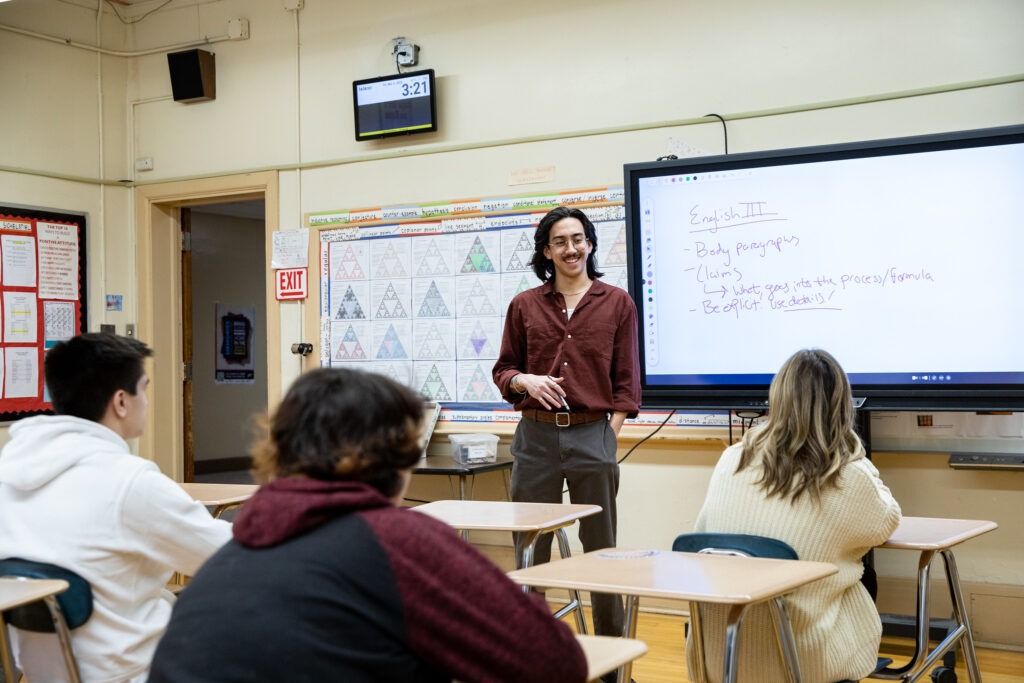 High school teacher leading a lesson on digital tools, illustrating real-world use of an educational technology degree
