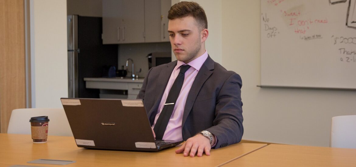 Professional student researching MBA online programs at work