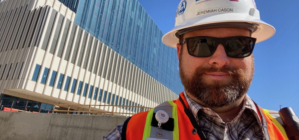 Construction professional wearing hard hat and safety vest at a job site representing bachelors degree in construction and construction management BS career opportunities