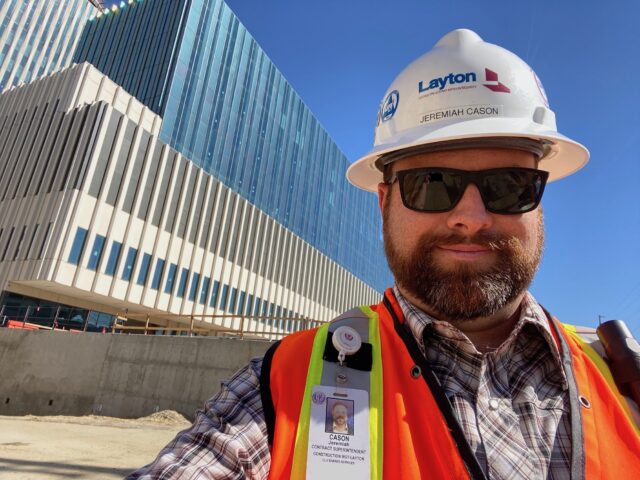 Construction professional wearing hard hat and safety vest at a job site representing bachelors degree in construction and construction management BS career opportunities