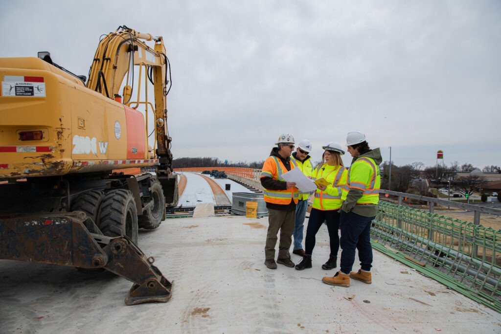 Group of construction professionals working together on infrastructure project highlighting career impact with a bachelors degree in construction