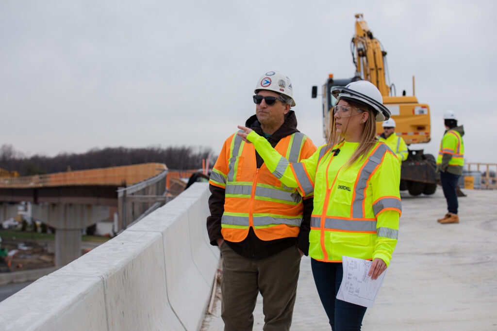 Construction managers reviewing plans on site symbolizing leadership skills taught in a construction management BS degree