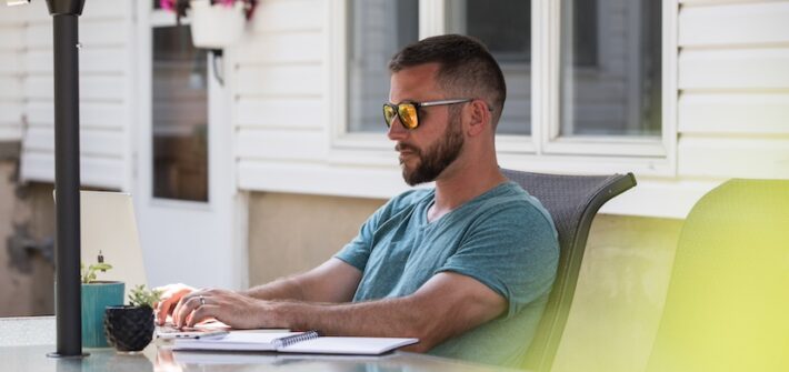 A Rowan Bachelor of Science of Nursing online BSN student studies in his backyard.