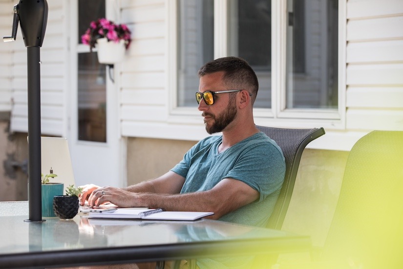 A Rowan Bachelor of Science of Nursing online BSN student studies in his backyard.