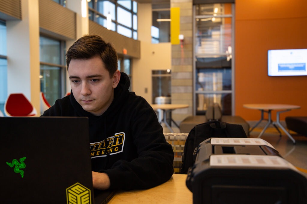 Prospective student researching best master's degree for engineers on computer.