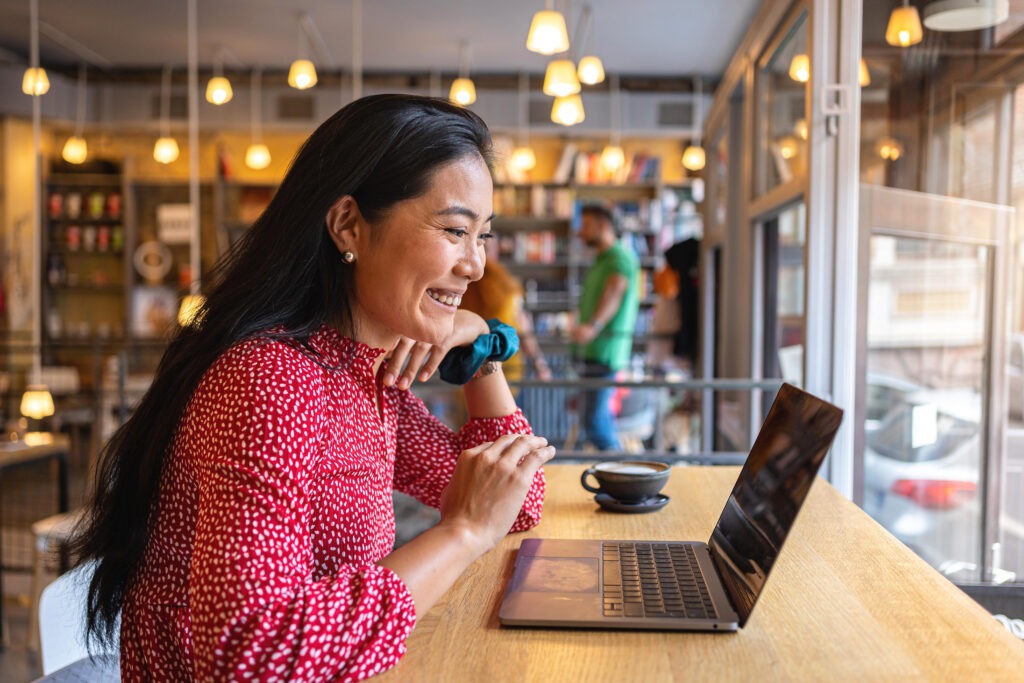 Student completing online coursework for bs in business administration program in a coffee shop